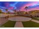 Relax in this backyard featuring grass, a pool, and desert landscaping at 15652 N 175Th Ct, Surprise, AZ 85388