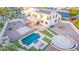 Aerial view of a beautiful backyard with a pool, patio, and solar panels on the home at 15652 N 175Th Ct, Surprise, AZ 85388