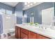 Bathroom featuring double sinks with wood cabinets and a tub and shower combo at 15652 N 175Th Ct, Surprise, AZ 85388