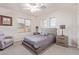 Bedroom with carpet, a ceiling fan, a chair, and two bedside tables at 15652 N 175Th Ct, Surprise, AZ 85388