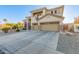 Beautiful two-story home showcasing a three-car garage, stone detailing, and a spacious driveway with desert landscaping at 15652 N 175Th Ct, Surprise, AZ 85388