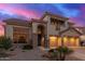 Beautiful home with a stone facade, three-car garage, and manicured front yard at 15652 N 175Th Ct, Surprise, AZ 85388