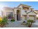 Attractive home with a three-car garage, stone details, and desert-friendly landscaping at 15652 N 175Th Ct, Surprise, AZ 85388