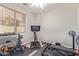 This spacious gym area includes stationary bike, weights, bench, and rubber floor at 15652 N 175Th Ct, Surprise, AZ 85388