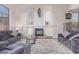 Cozy living room featuring a fireplace, comfortable seating, and bright natural light at 15652 N 175Th Ct, Surprise, AZ 85388