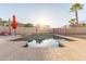 Private backyard pool with red umbrellas, perfect for leisurely afternoons and outdoor enjoyment at 15652 N 175Th Ct, Surprise, AZ 85388