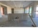 Unfinished kitchen showcasing plumbing, wiring, and open concept design with a view into the living space at 15770 W Cheryl Dr, Waddell, AZ 85355