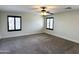 Bright bedroom with plush carpeting, neutral walls, and two windows with modern shutters at 1637 W Green Tree Dr, San Tan Valley, AZ 85144