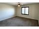 Bedroom featuring neutral walls, plush carpeting, and a window with modern shutters at 1637 W Green Tree Dr, San Tan Valley, AZ 85144