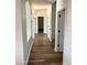 Bright hallway with wood-look tile flooring and arched doorways at 1637 W Green Tree Dr, San Tan Valley, AZ 85144