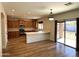 Open-concept kitchen with island, stainless steel appliances, and sliding glass door at 1637 W Green Tree Dr, San Tan Valley, AZ 85144