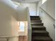 Carpeted staircase with white railings and a view of the wood floors below at 1637 W Green Tree Dr, San Tan Valley, AZ 85144