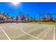 Community basketball court featuring well-maintained court, trees, and open space at 1664 E Bridgeport Pkwy, Gilbert, AZ 85295