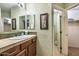 Elegant bathroom boasts beautiful wallpaper, a well-lit vanity area, and a doorway leading to another room at 1664 E Bridgeport Pkwy, Gilbert, AZ 85295