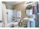 Cozy bathroom featuring a shower-tub combo, pedestal sink, and neutral color palette at 1664 E Bridgeport Pkwy, Gilbert, AZ 85295