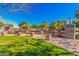 Beautiful community park featuring lush green grass, walkways, large planters, and shade trees on a sunny day at 1664 E Bridgeport Pkwy, Gilbert, AZ 85295