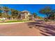 Community entrance featuring landscaped grounds, decorative stonework, and a charming guardhouse at 1664 E Bridgeport Pkwy, Gilbert, AZ 85295