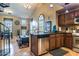 Open concept kitchen featuring stainless steel appliances, dark wood cabinets, and granite countertops at 1664 E Bridgeport Pkwy, Gilbert, AZ 85295