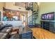 Living room area with a dark wood entertainment center and spiral staircase to an upper floor at 1664 E Bridgeport Pkwy, Gilbert, AZ 85295