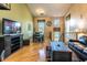 Bright, open living room with wood floors, a dining area, and comfortable seating around a dark wood coffee table at 1664 E Bridgeport Pkwy, Gilbert, AZ 85295