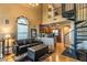 Inviting living room with a modern kitchen, spiral staircase, and an abundance of natural light at 1664 E Bridgeport Pkwy, Gilbert, AZ 85295