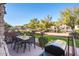 Outdoor patio area with dining table, chairs, built-in BBQ, and garden views at 1664 E Bridgeport Pkwy, Gilbert, AZ 85295