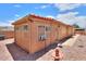 A small table and chairs are positioned beside the house, with the backyard covered in gravel at 1762 N Terrace Cir, Casa Grande, AZ 85122