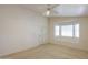 Bright bedroom with a bay window and neutral carpet, complemented by a ceiling fan at 1762 N Terrace Cir, Casa Grande, AZ 85122