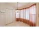 Dining area features a modern chandelier and large windows with curtains at 1762 N Terrace Cir, Casa Grande, AZ 85122