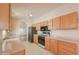 Open-concept kitchen features black appliances and light wood cabinets at 1762 N Terrace Cir, Casa Grande, AZ 85122