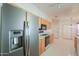 Well-lit kitchen features stainless steel refrigerator and access to dining area at 1762 N Terrace Cir, Casa Grande, AZ 85122