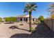 Well maintained backyard with desert landscaping and a view of the covered patio at 17697 W Sunbelt Dr, Surprise, AZ 85374