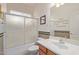 Bathroom featuring a sink with cabinet and combination bathtub and shower with glass doors at 17697 W Sunbelt Dr, Surprise, AZ 85374