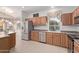 Well-lit kitchen with stainless steel appliances, wooden cabinetry, and tiled flooring at 17697 W Sunbelt Dr, Surprise, AZ 85374