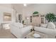 Spacious living room featuring neutral tones, vaulted ceilings, and stylish furnishings at 17697 W Sunbelt Dr, Surprise, AZ 85374