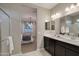 View from bathroom showing double sinks, glass enclosed shower and view into the main bedroom at 1780 W Sombra Ave, Apache Junction, AZ 85120