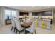 Open-concept dining area with seating for six, a view of the kitchen, and bright natural light at 1780 W Sombra Ave, Apache Junction, AZ 85120