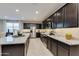 Modern kitchen featuring stainless steel appliances, spacious granite countertops, and dark wood cabinetry at 1780 W Sombra Ave, Apache Junction, AZ 85120