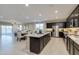 Modern kitchen featuring stainless steel appliances, an island with bar seating, and access to dining and living spaces at 1780 W Sombra Ave, Apache Junction, AZ 85120