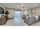 Cozy living room showcasing a gray sofa, an accent chair, and a sliding door to the backyard at 1780 W Sombra Ave, Apache Junction, AZ 85120