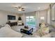 Comfortable living room featuring a gray sectional sofa and sliding glass doors leading to the yard at 1780 W Sombra Ave, Apache Junction, AZ 85120