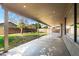 Covered patio overlooks green backyard with brick wall and mature tree at 1846 N Sunview --, Mesa, AZ 85205