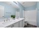 Bright bathroom featuring dual sinks, a large mirror, and a tub and shower combo at 1846 N Sunview --, Mesa, AZ 85205