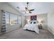 Bright bedroom with a ceiling fan, zebra wall art, and large window at 1846 N Sunview --, Mesa, AZ 85205