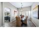 Dining room with wicker chairs and wood floors has a view of the modern kitchen at 1846 N Sunview --, Mesa, AZ 85205