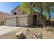 Two-story home with a three-car garage, neutral exterior, and desert landscaping for low maintenance at 1846 N Sunview --, Mesa, AZ 85205