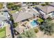 Aerial view of the house showcasing the backyard, pool, lounge area, fire pit, and well-manicured landscaping at 19727 E Julius Rd, Queen Creek, AZ 85142