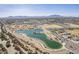 Aerial view showcases a community park with a lake, sports fields, and walking trails, set against a mountain backdrop at 19727 E Julius Rd, Queen Creek, AZ 85142