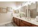 Bathroom with a double vanity, marble countertops, decorative mirrors, and a tub-shower combo at 19727 E Julius Rd, Queen Creek, AZ 85142