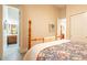 Bedroom with en-suite bathroom access and natural light, with neutral paint and light-colored flooring at 19727 E Julius Rd, Queen Creek, AZ 85142